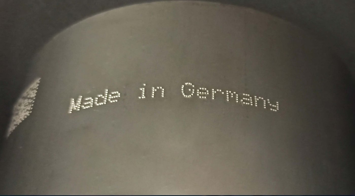 Raw image — stamped code on part
